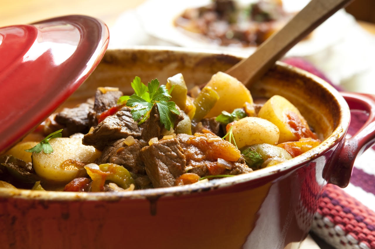 Traditional goulash or beef stew, in red crock pot, ready to serve. Shallow DOF.